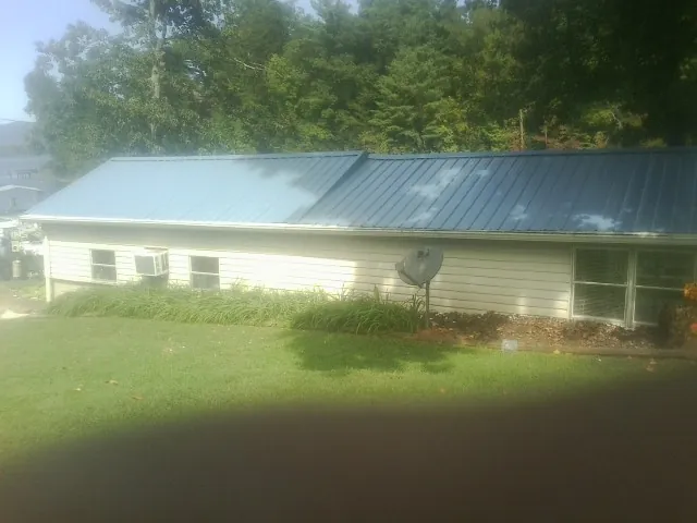 Blue metal roof running the length of a single story home in Willow Springs